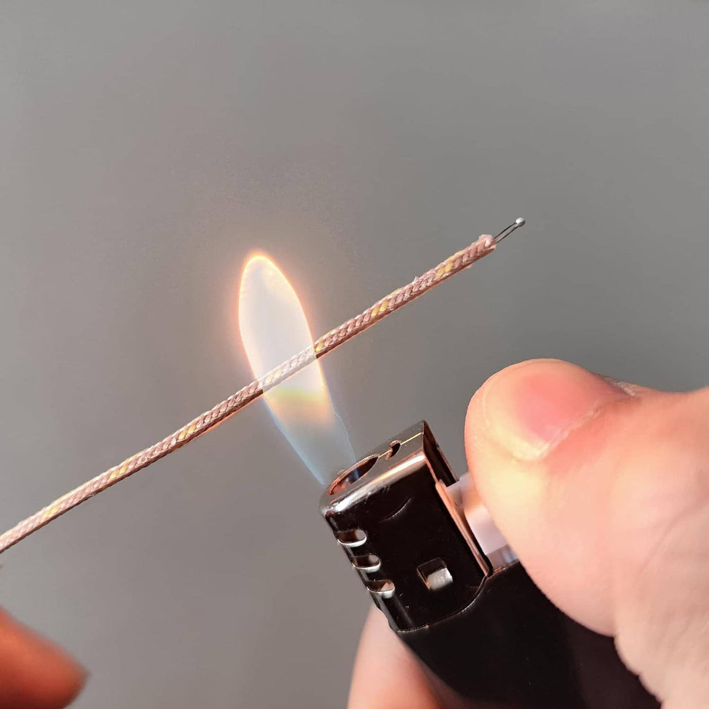 K-type thermocouple mini connector plug with two-pin leads held by hand