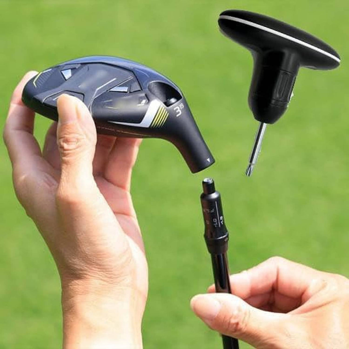 Golf torque wrench held in hand with screwdriver-style bit and round head