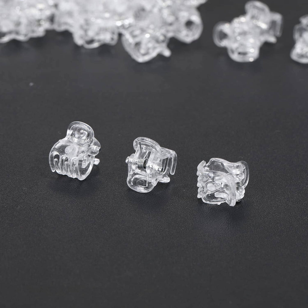 Clear mini claw hair clips scattered, showing different angles of the clips