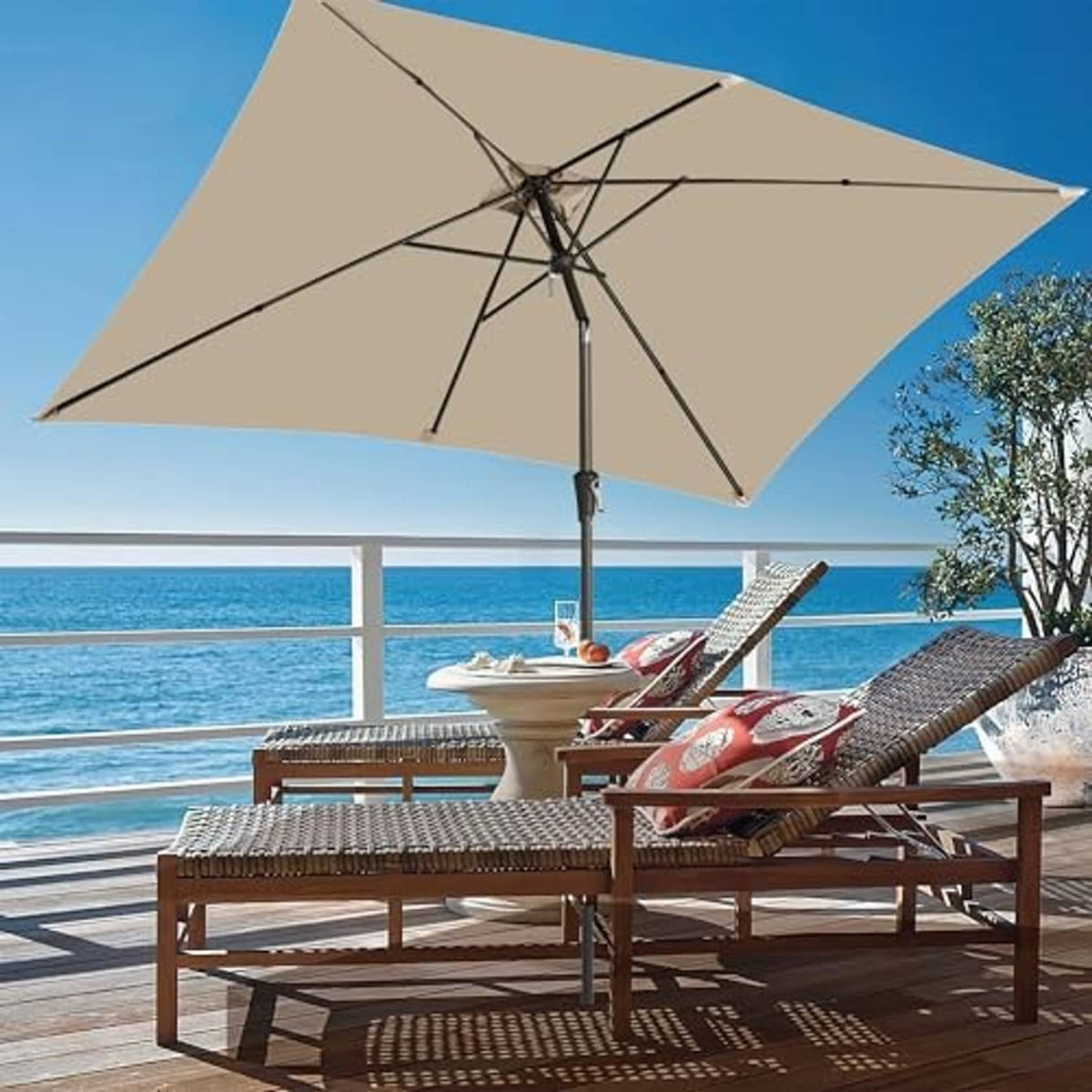 Beige rectangular patio umbrella open over outdoor seating, central pole and canopy visible