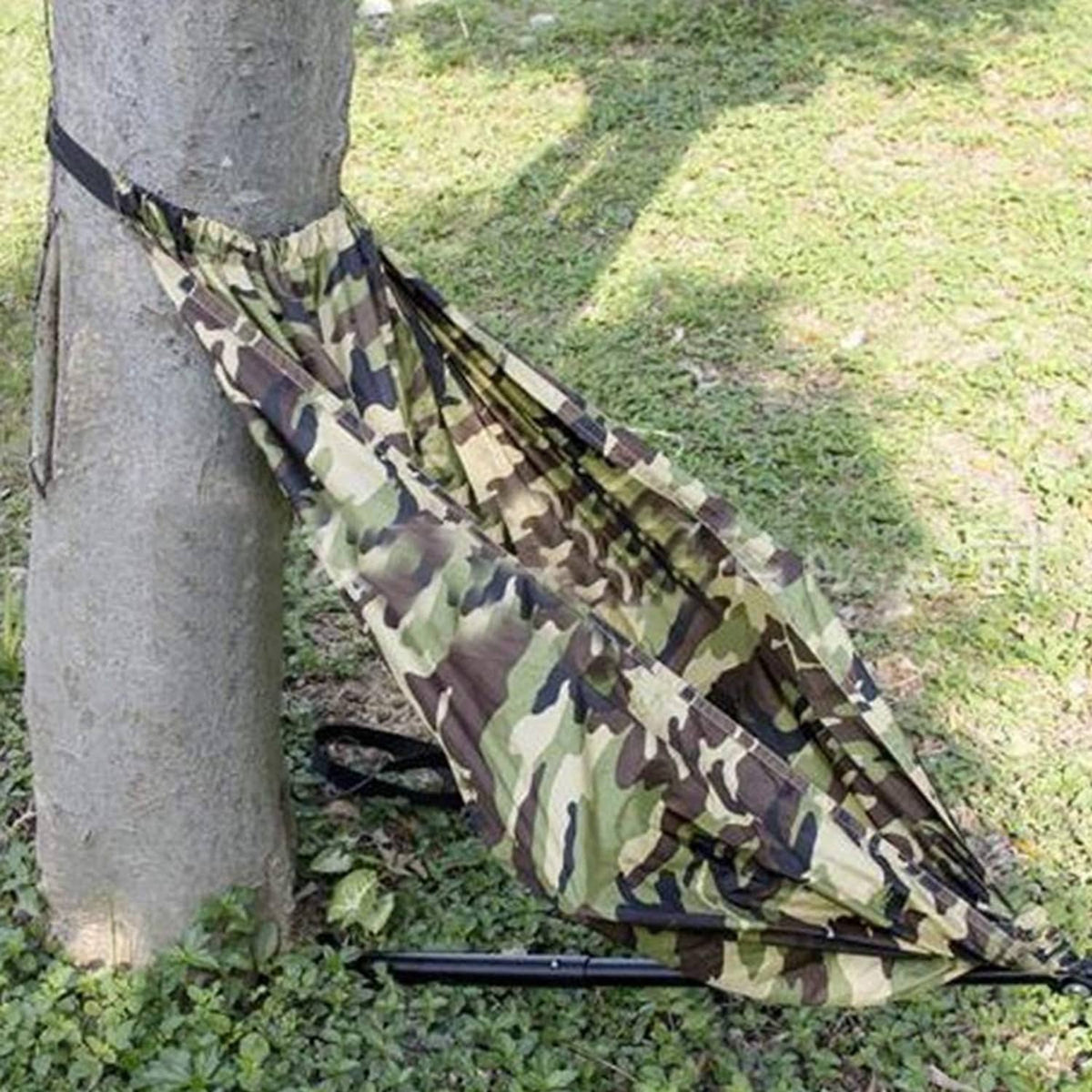 Camouflage hammock camping chair tied to a tree, with black support bar