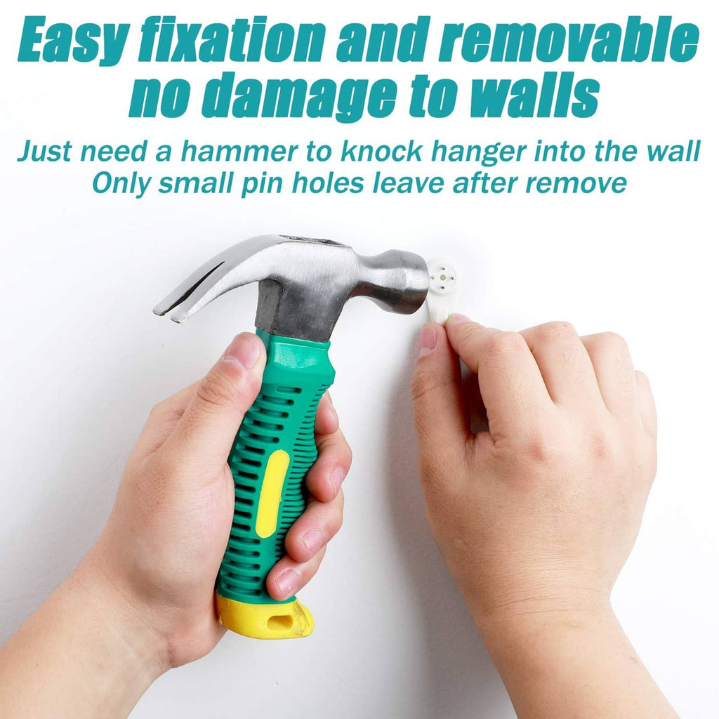 White plastic wall hanger hook being hammered in by two hands