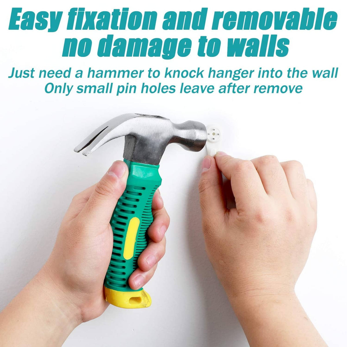 White plastic wall hanger hook being hammered in by two hands