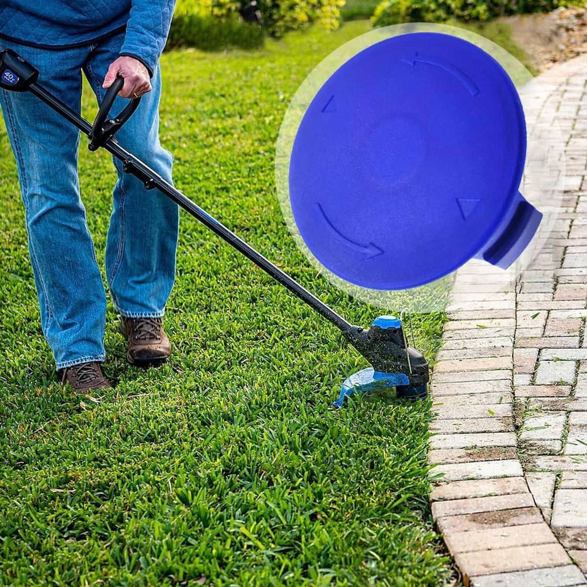 Blue spool cap cover on string trimmer head trimming lawn grass