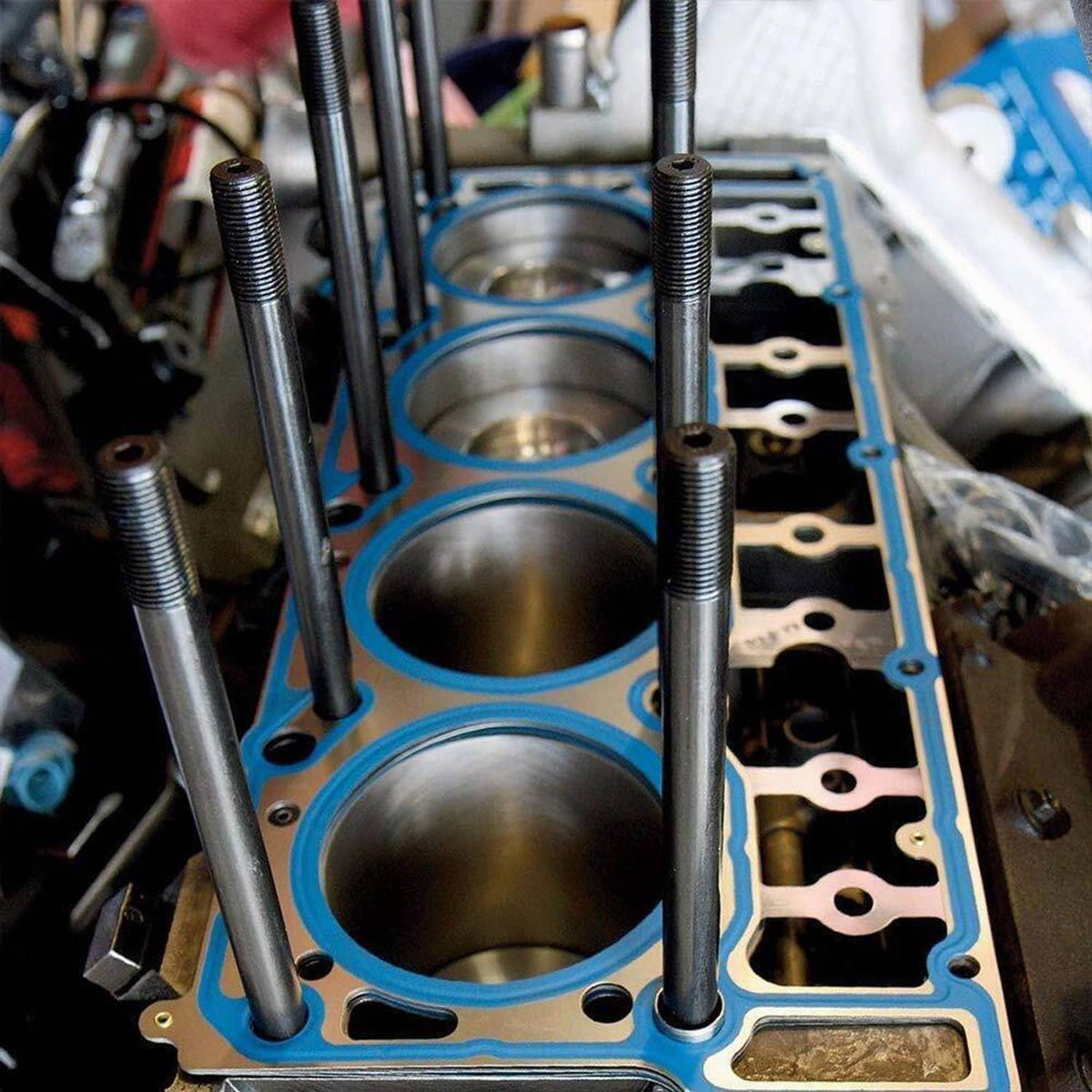 Installed black engine head studs standing in a cylinder head