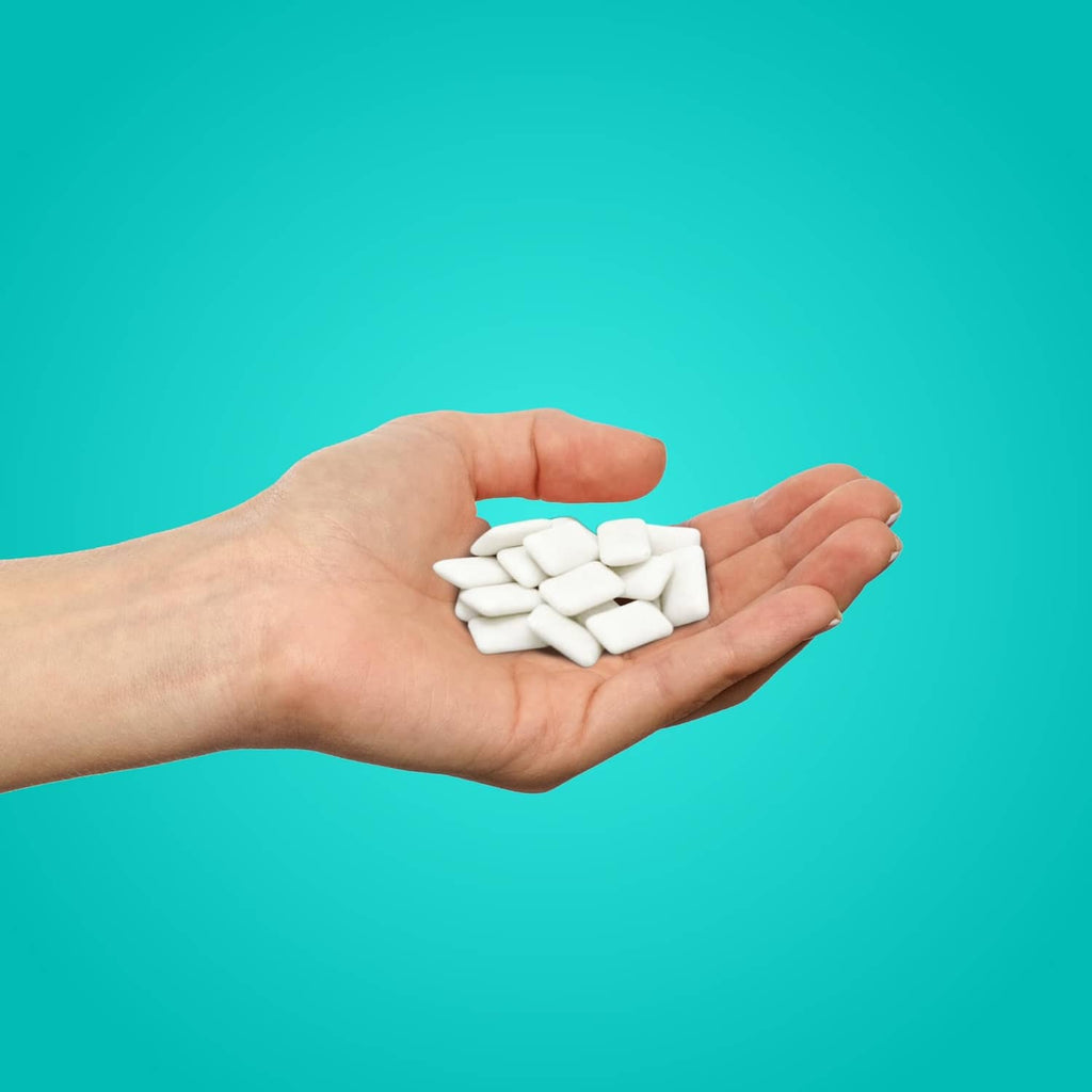 Wintergreen xylitol gum pieces in hand, PUR