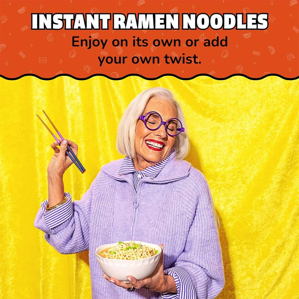 Instant ramen noodle soup bowl with noodles held in front of empty background