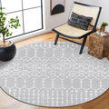 Grey round rug with white Moroccan trellis pattern, bordered edge, low pile