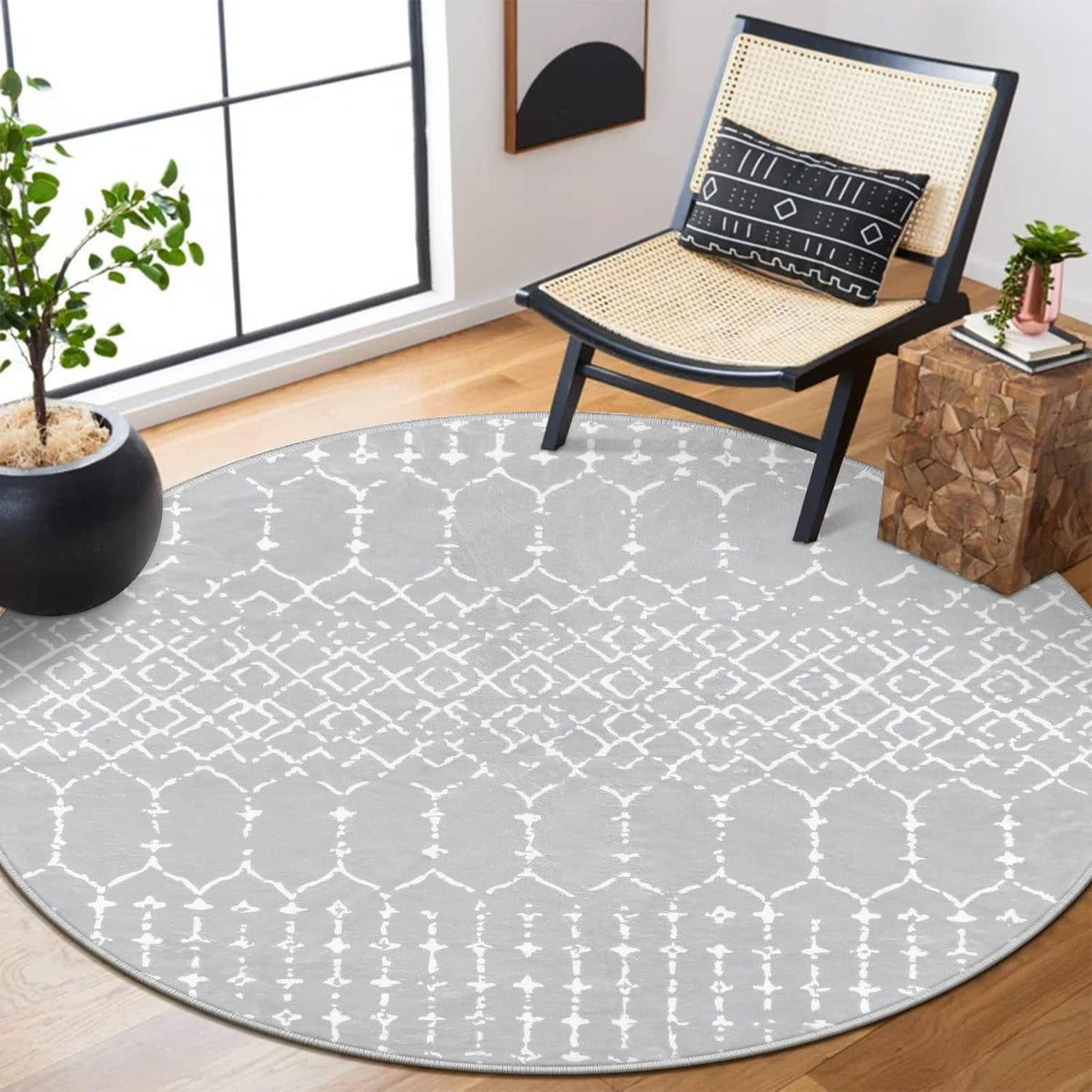Grey round rug with white Moroccan trellis pattern, bordered edge, low pile