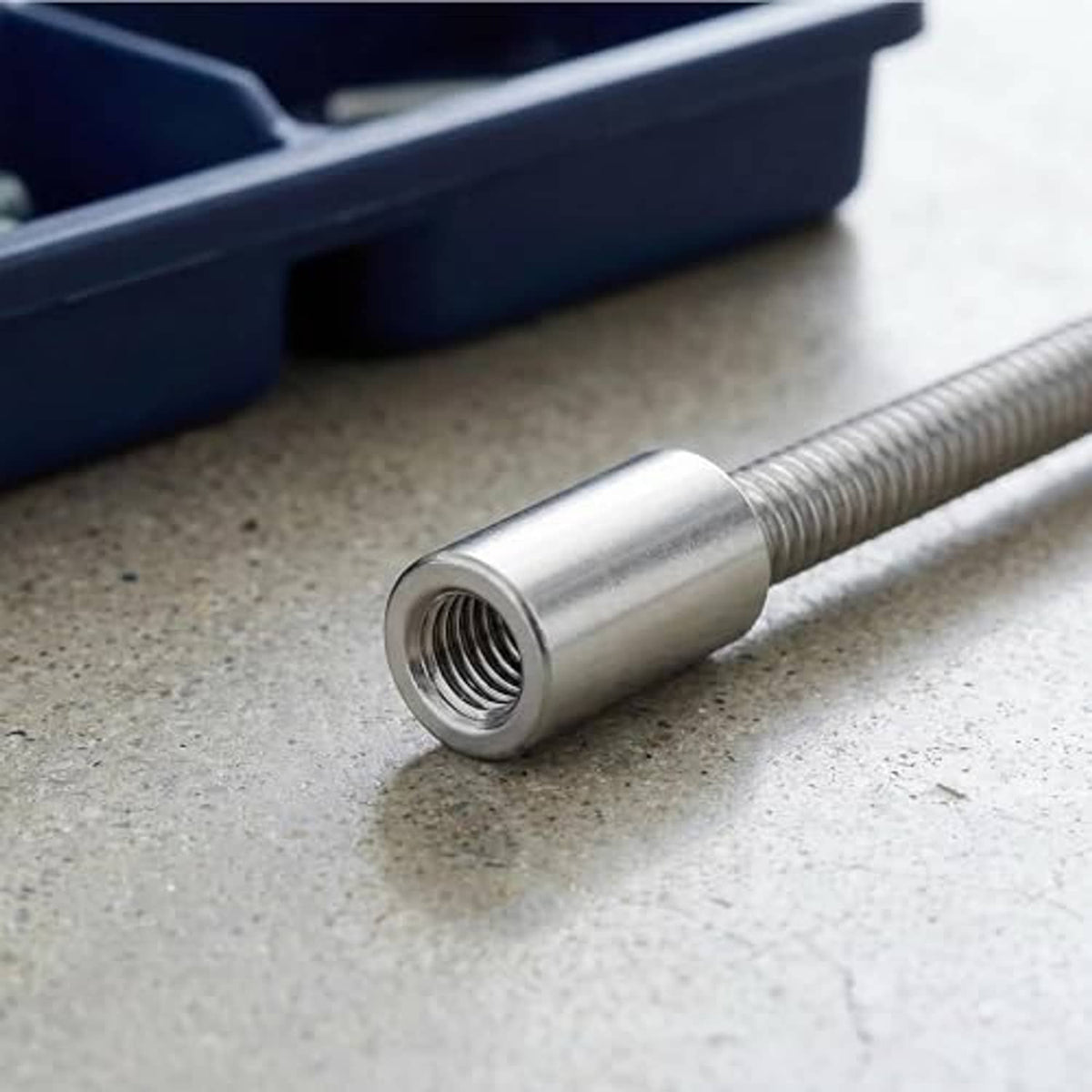 Stainless steel M6 threaded coupling sleeve fitted on a threaded rod