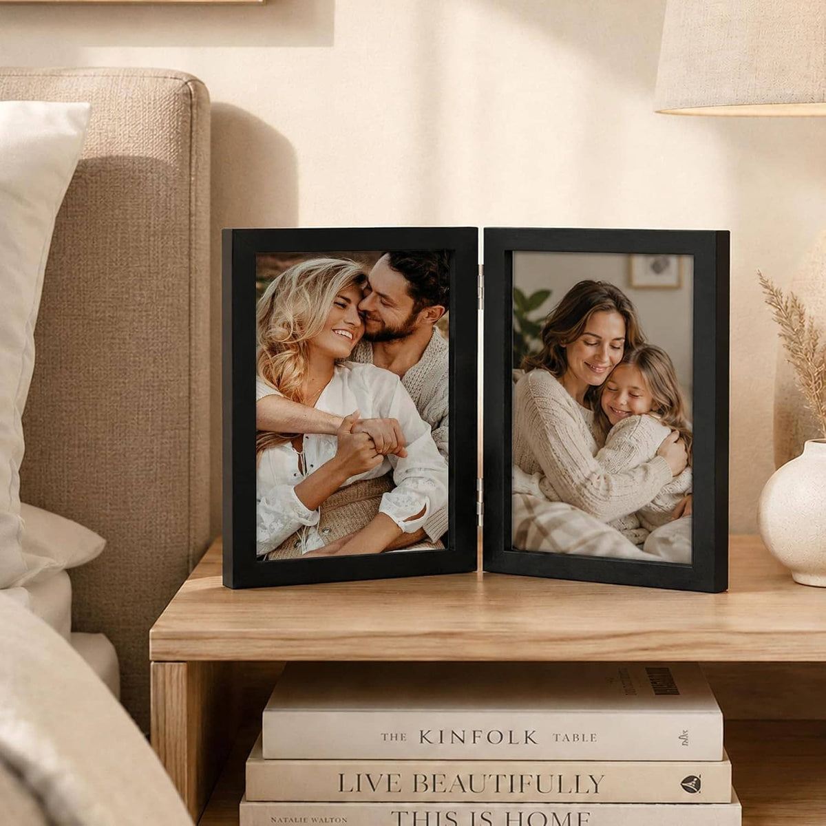 Black folding wood photo frame set with two hinged panels displaying portrait photos