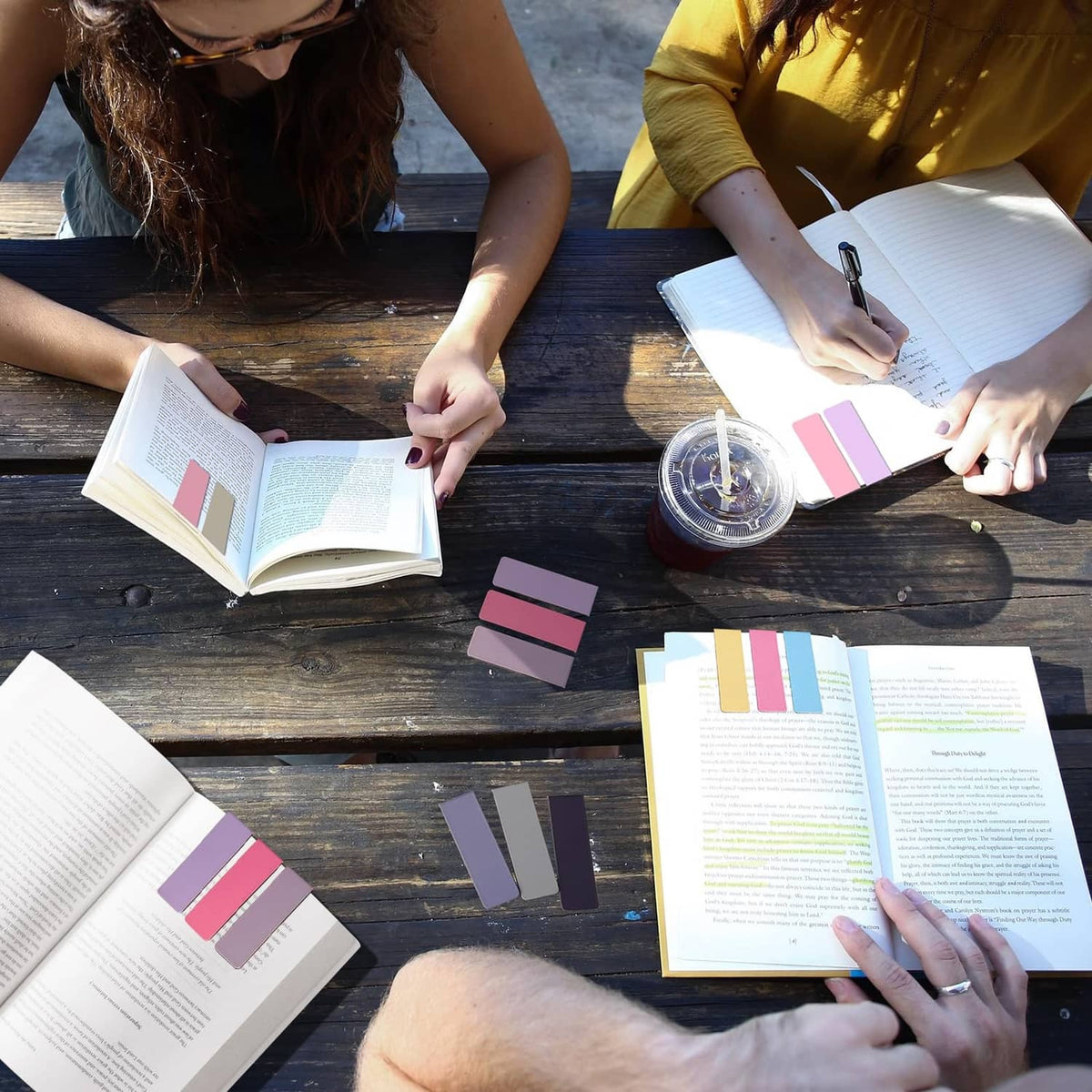 Magnetic bookmarks on open books, colorful tab markers placed in reading