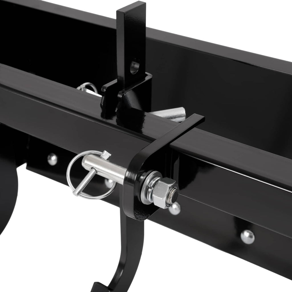 Close-up of latch pin and black scraper blade crossbar on tow-behind attachment