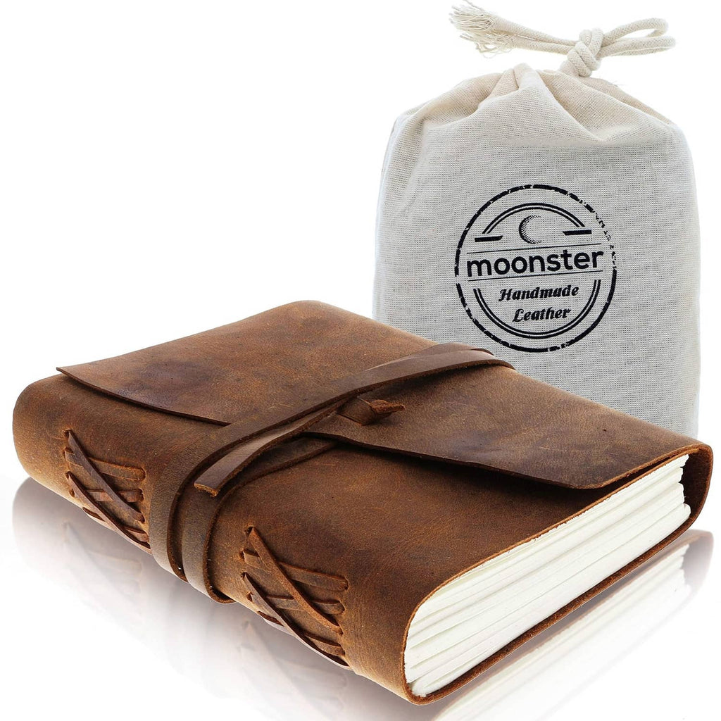 Brown leather journal notebook with wrap strap, shown with a handmade leather pouch.