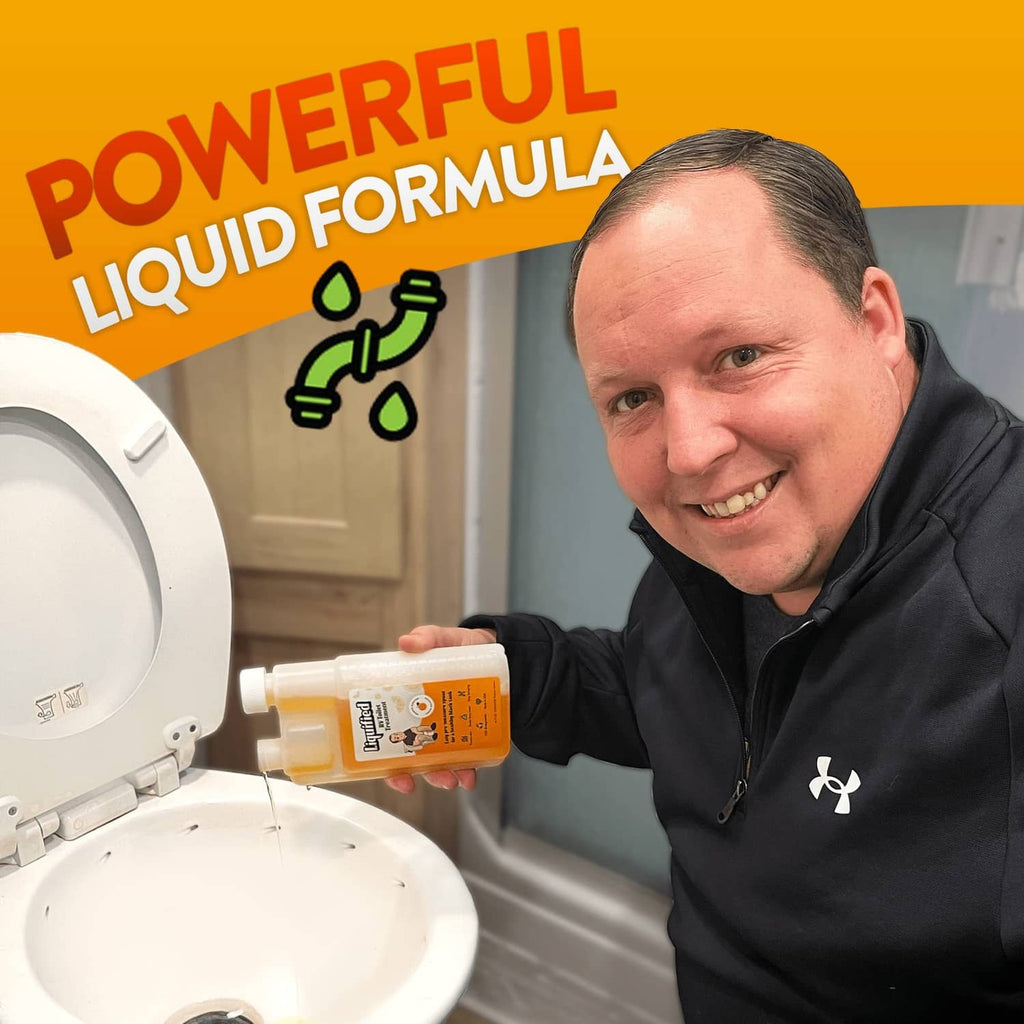 Liquified RV toilet treatment bottle with orange liquid held near RV toilet fixture