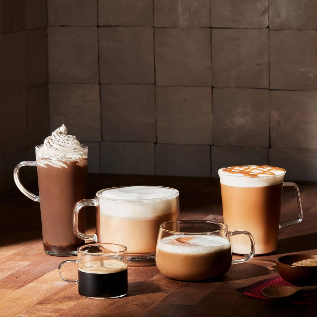 Assorted brewed coffee drinks in mugs for Folgers Breakfast Blend pods.