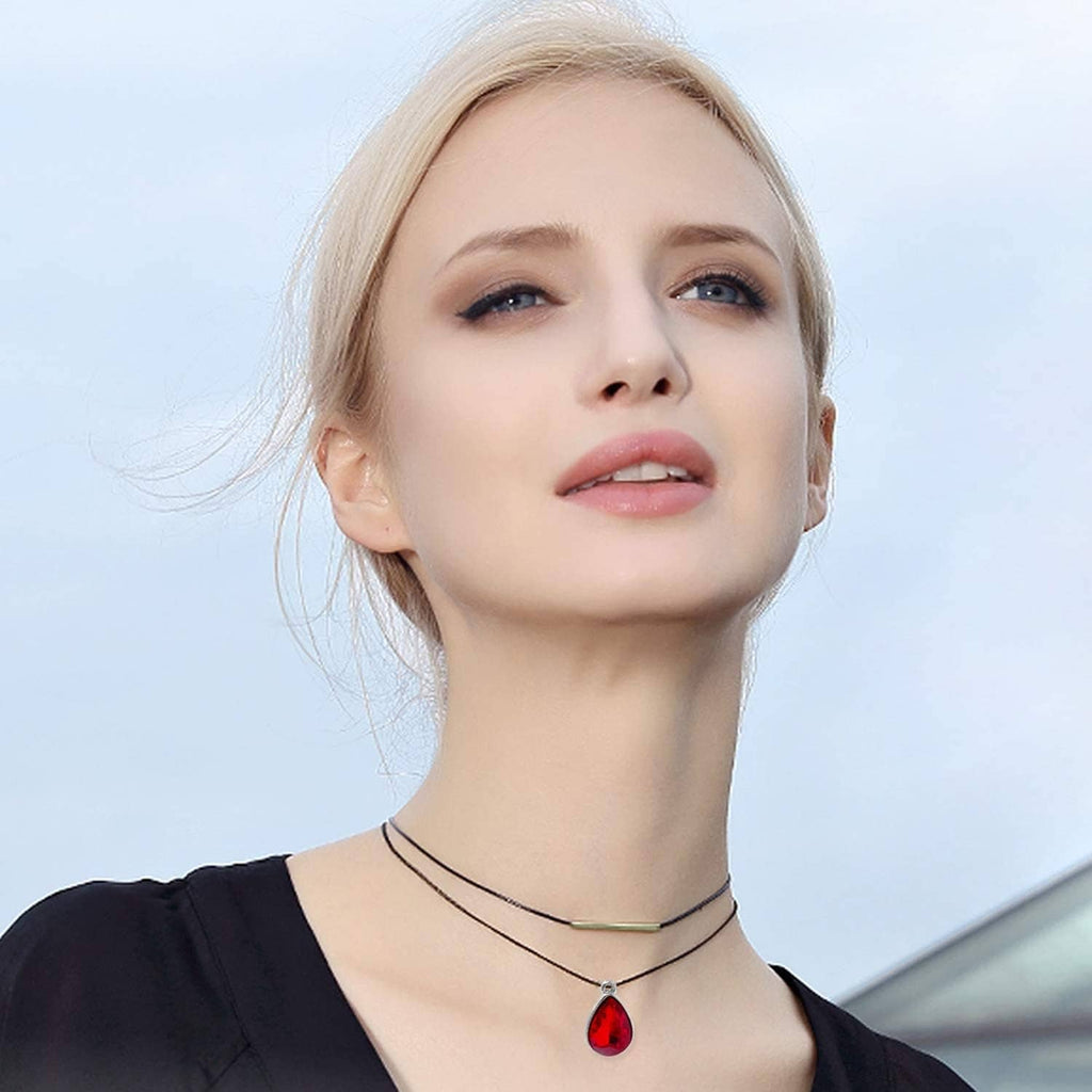 Red teardrop crystal pendant on a thin chain necklace with small silver-tone bail.