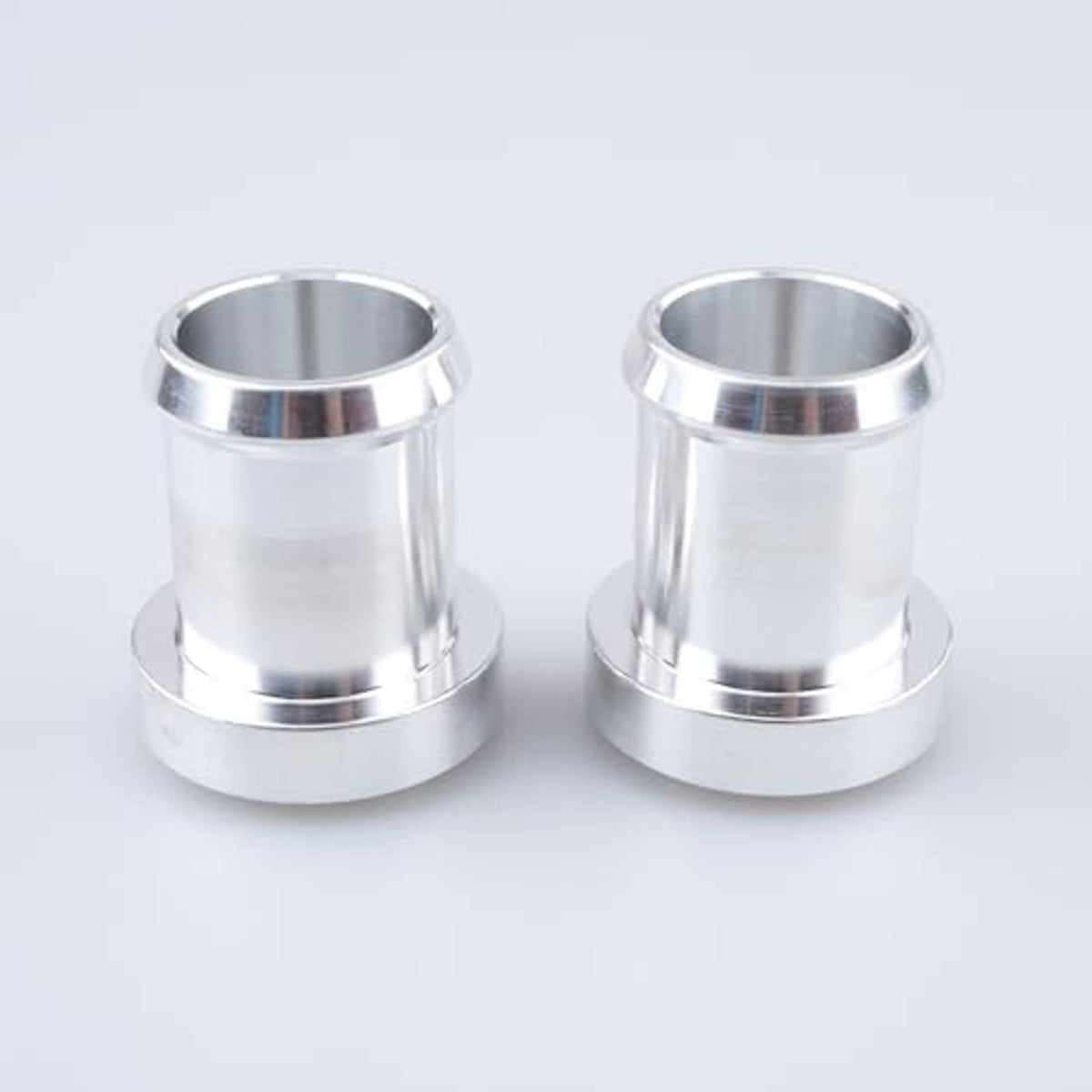Pair of stainless steel weldable hose barb tail fittings, front view with flange