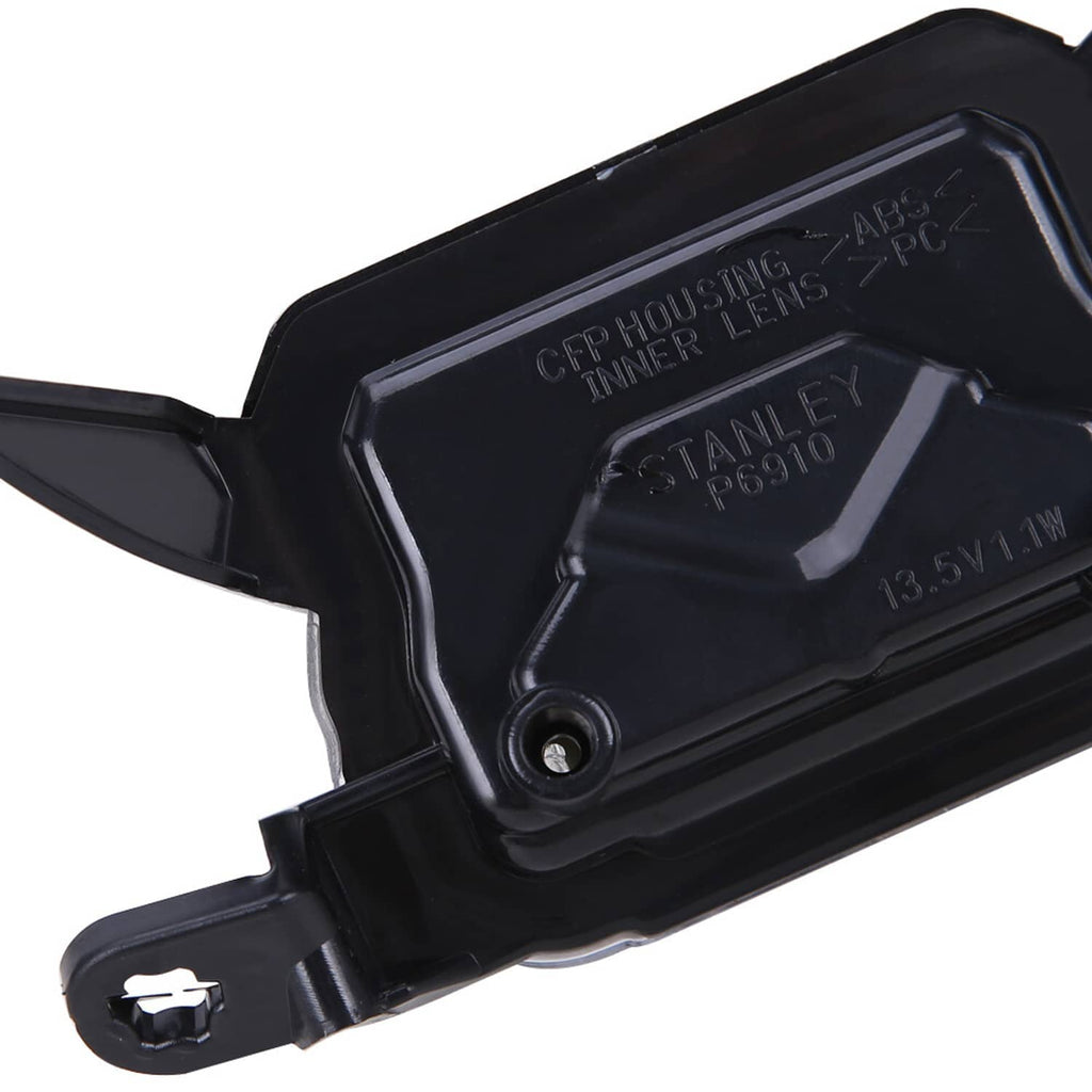 Black rear cover of front motorcycle headlight assembly with visible label and mounting studs