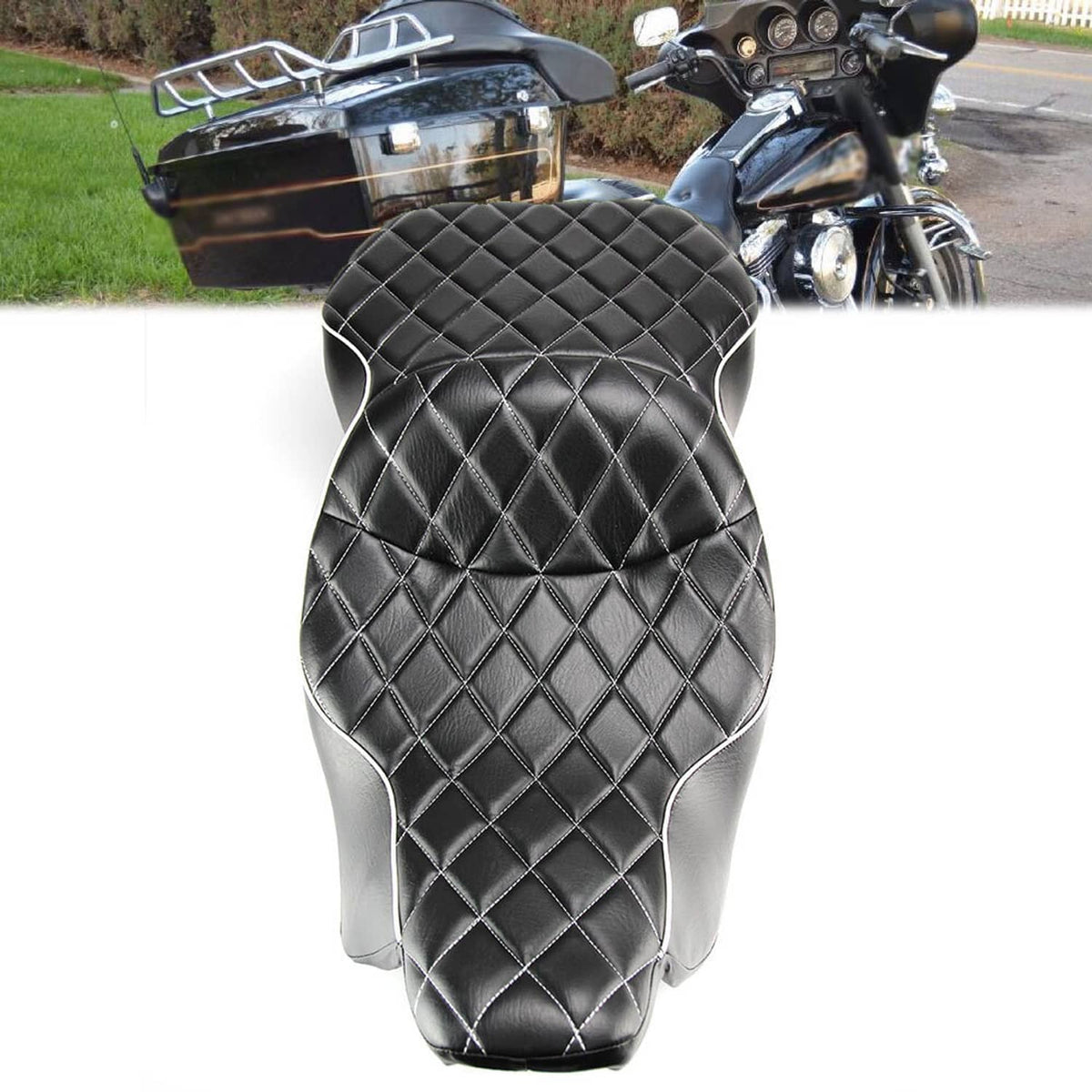 Black quilted motorcycle seat with diamond pattern and silver trim, top-down close view