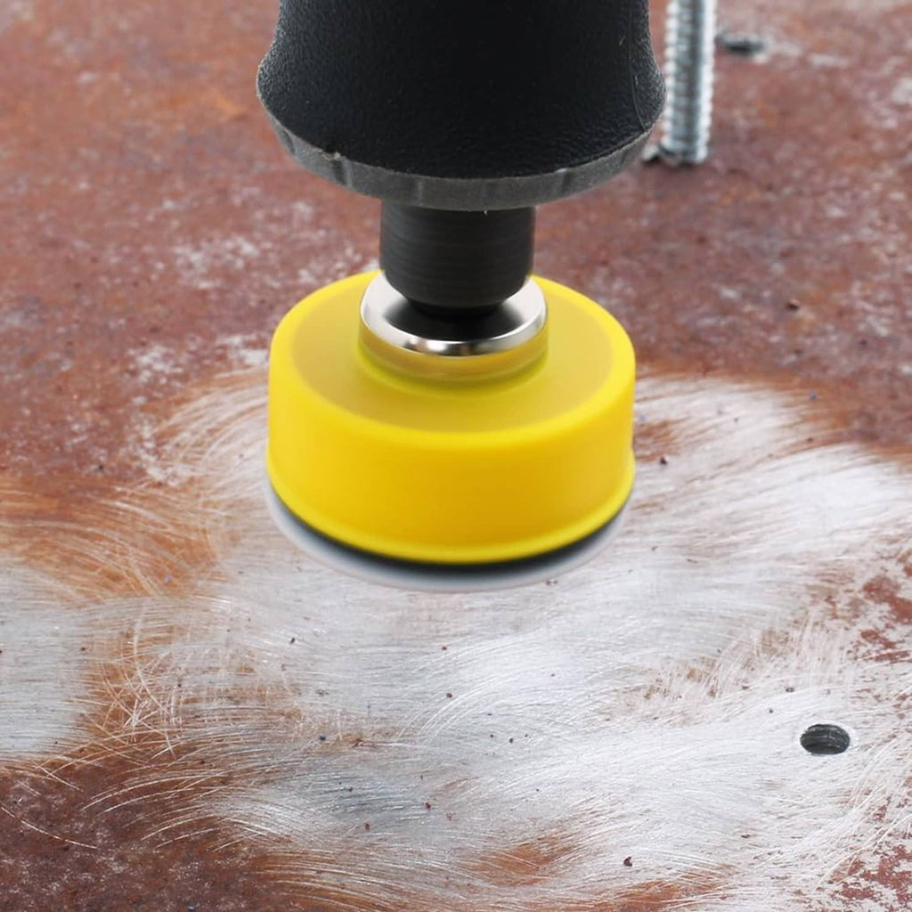 Yellow-backed sanding disc on wood surface with spinning tool for detail sanding