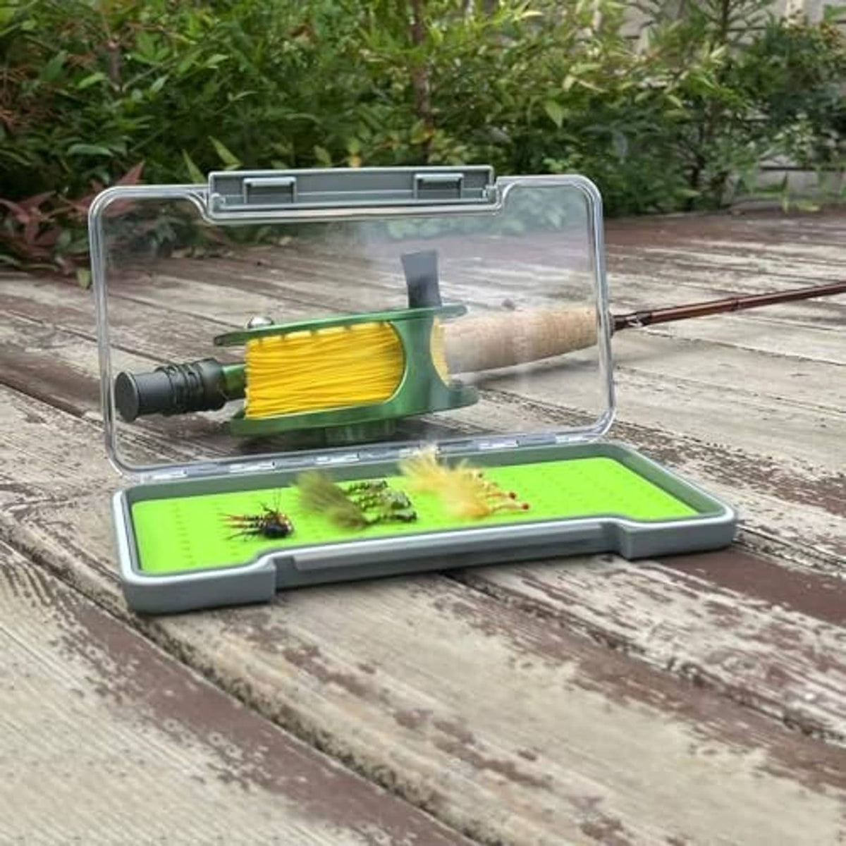 Clear-lidded waterproof fly fishing tackle box with green silicone insert and pegs