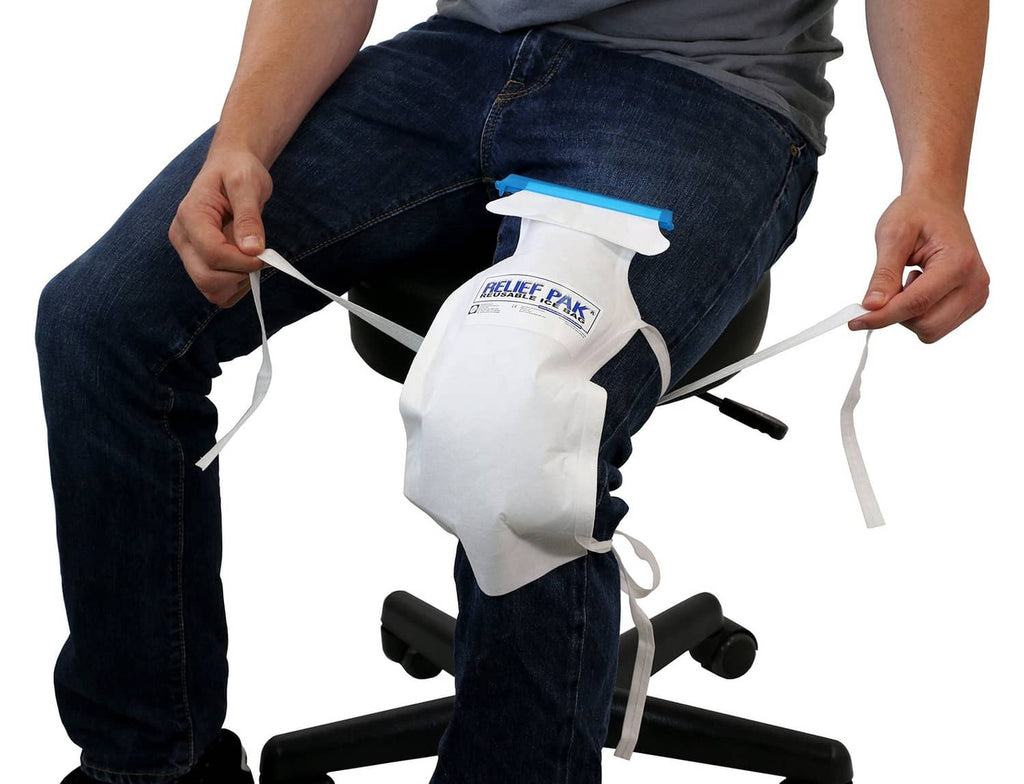 Insulated ice bag with long white tie strings and blue top tab, secured on leg