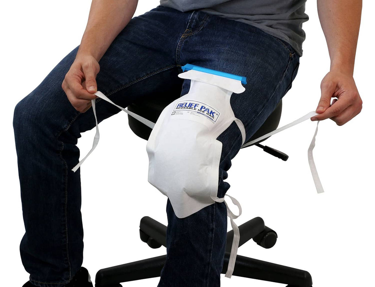 Insulated ice bag with long white tie strings and blue top tab, secured on leg