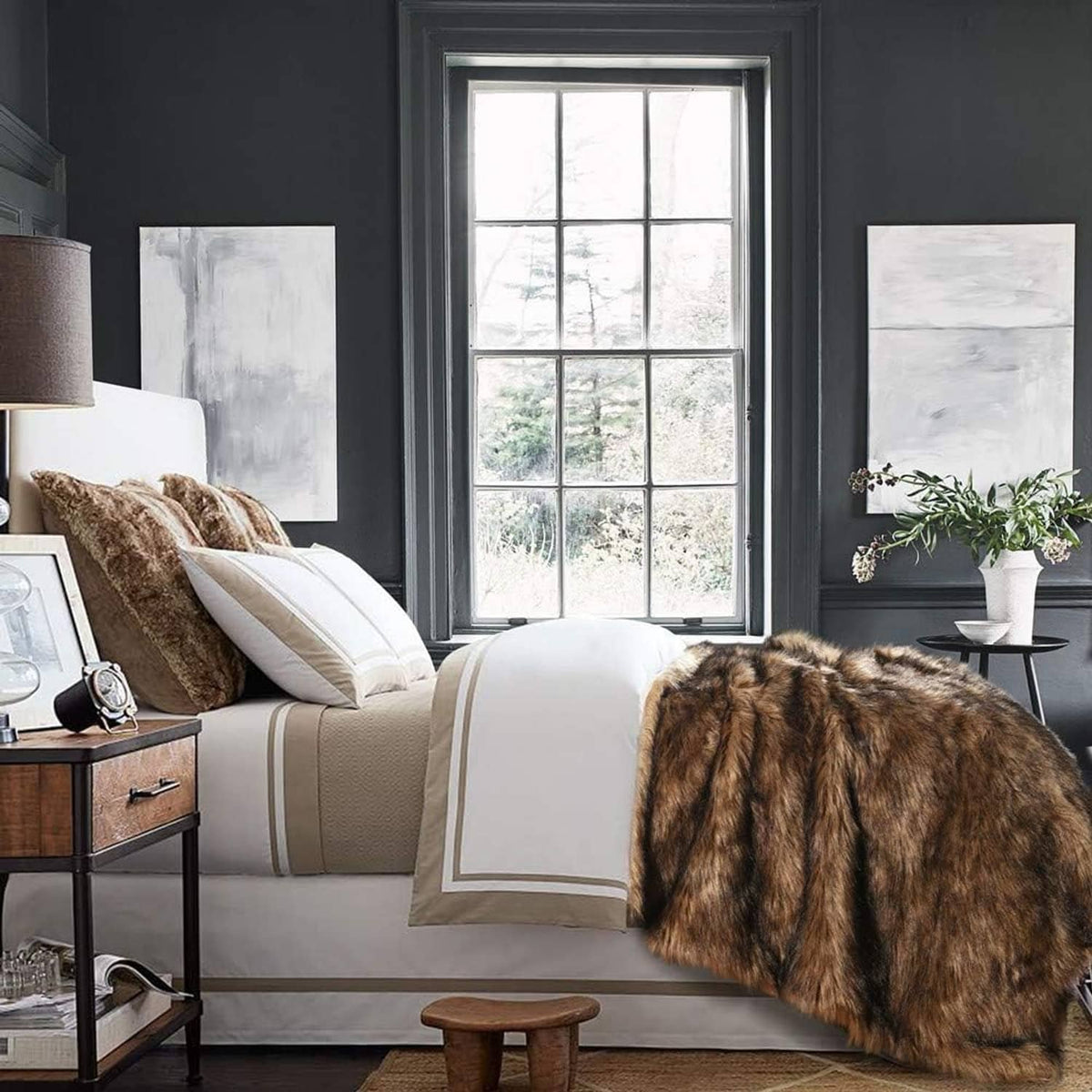 Brown long-pile faux fur blanket with black tips, draped over chair arm