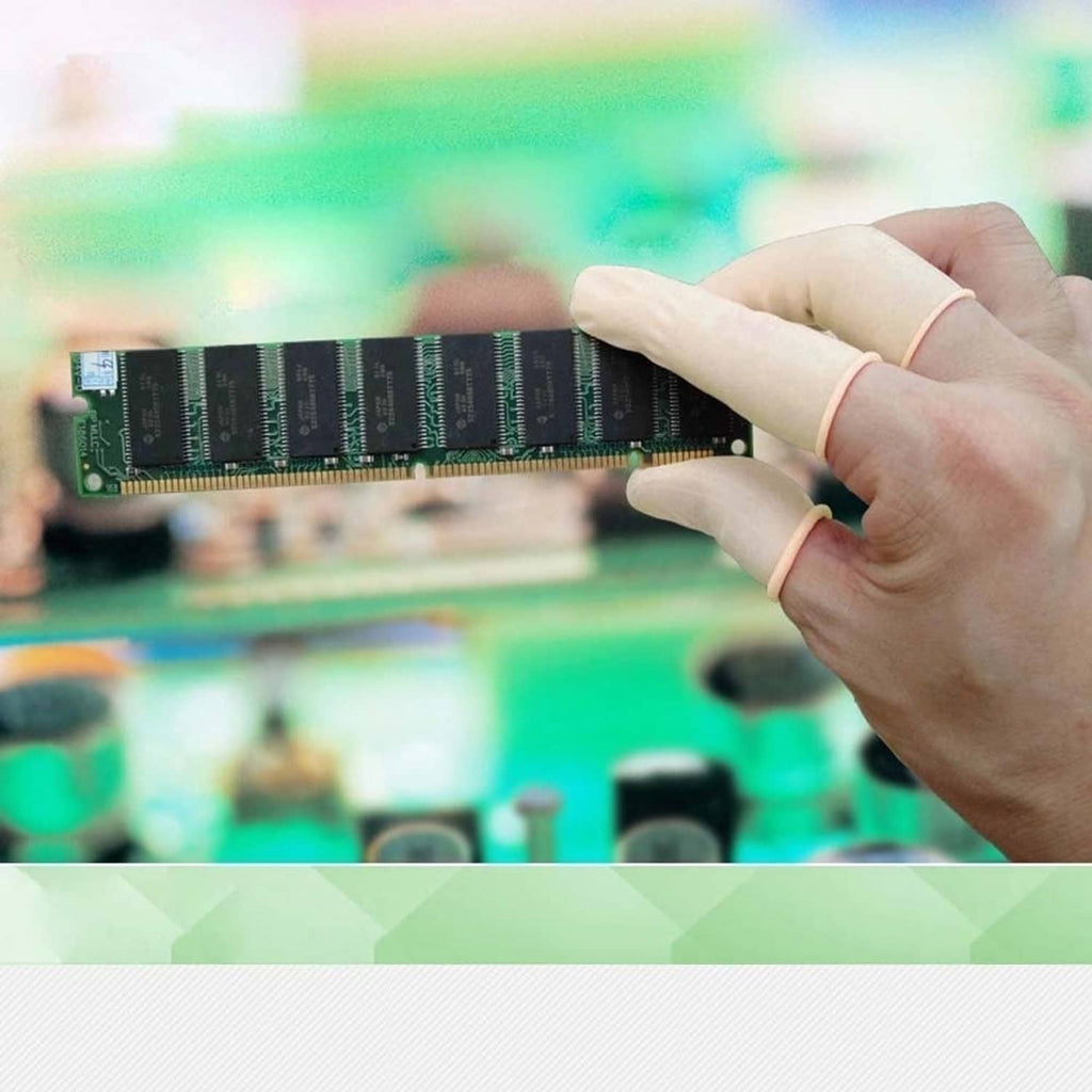 White latex finger cots worn while handling a circuit board component
