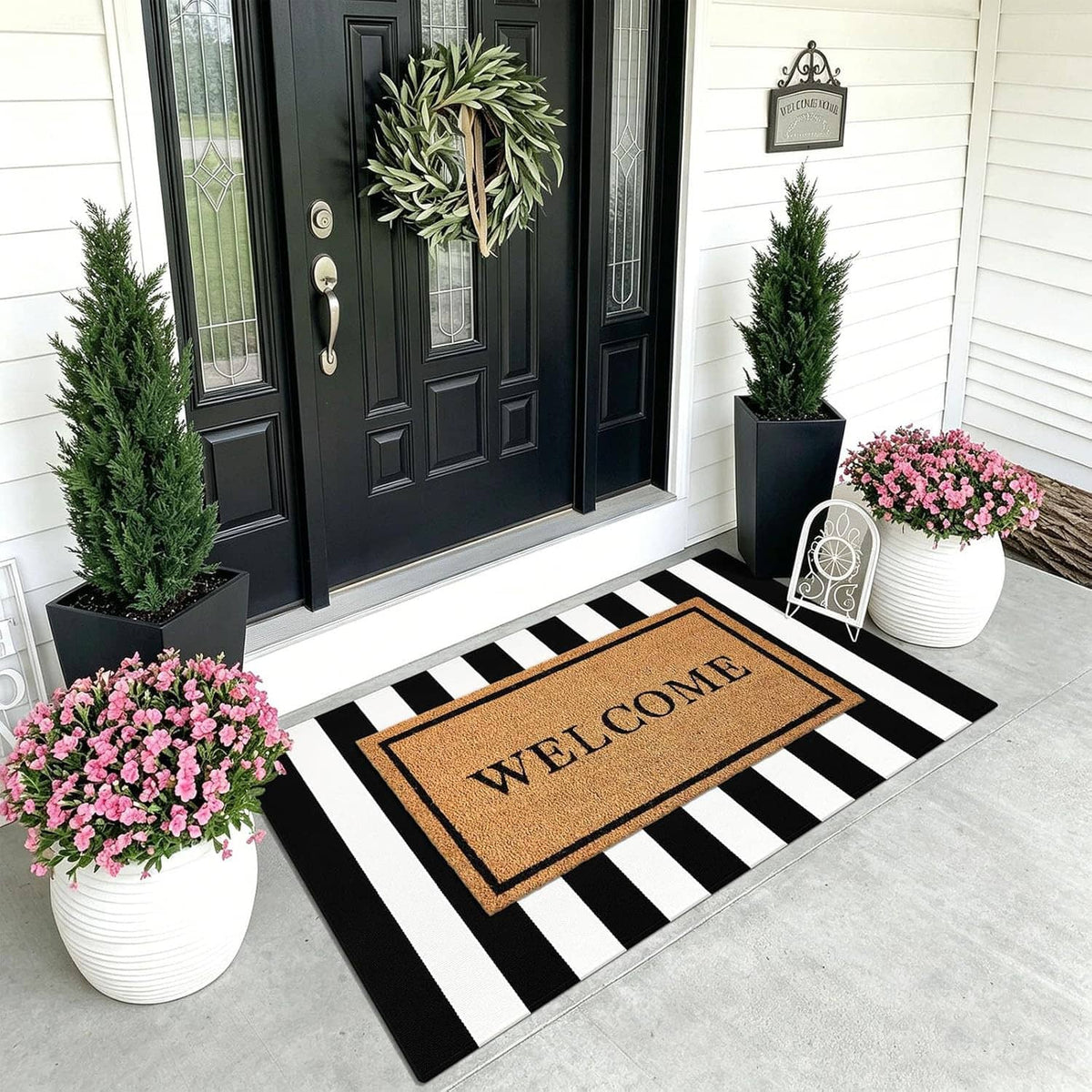 Black-and-white striped area rug with a bordered "WELCOME" center design.