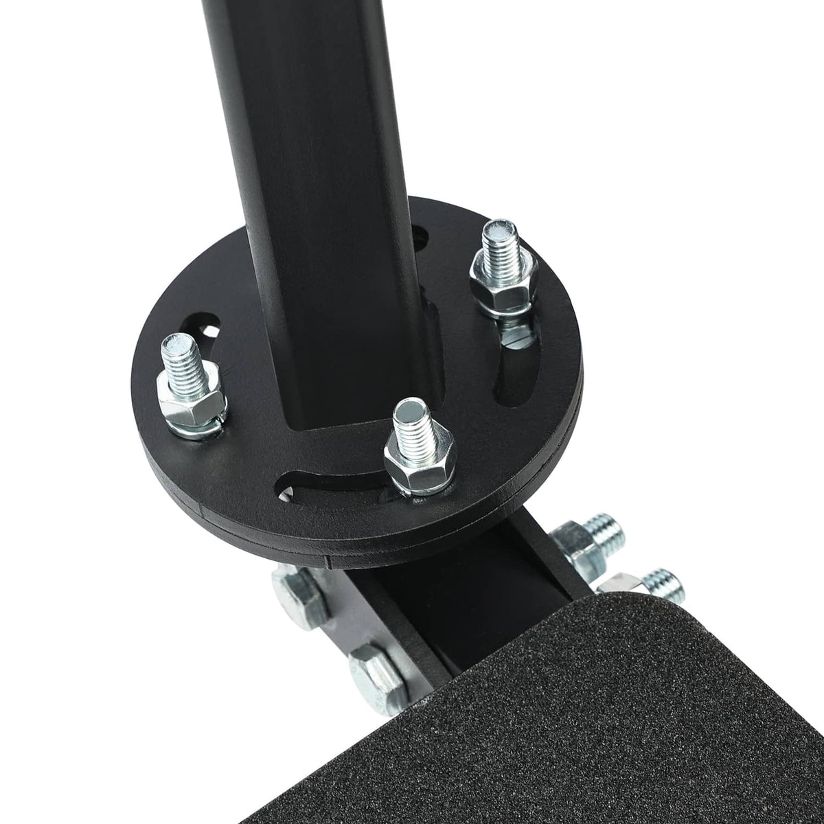 Close-up of black round base plate with bolts and textured step tread