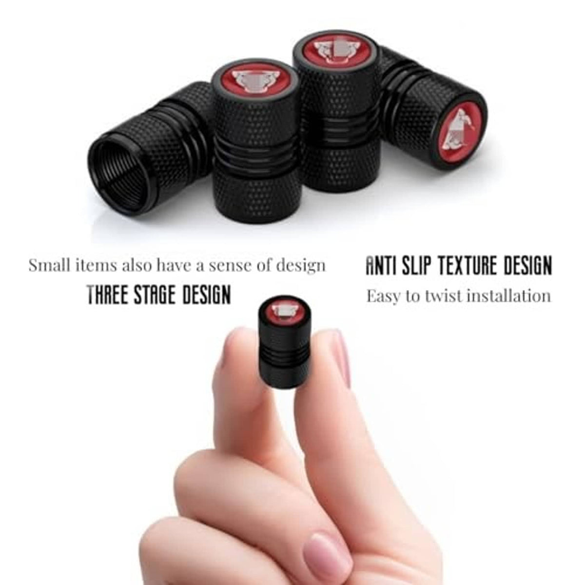 Black textured valve stem caps with red emblem, one cap held between fingers