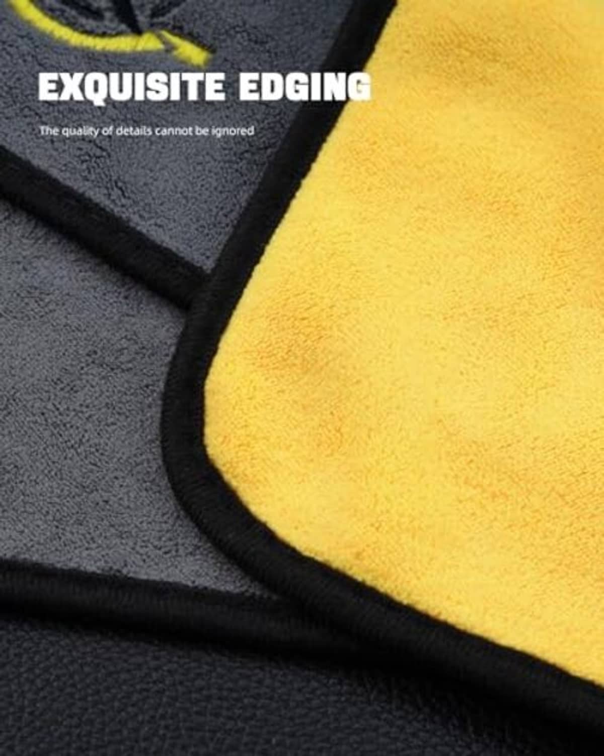 Close-up of dark gray cue cleaning towel edge with yellow surface and black binding