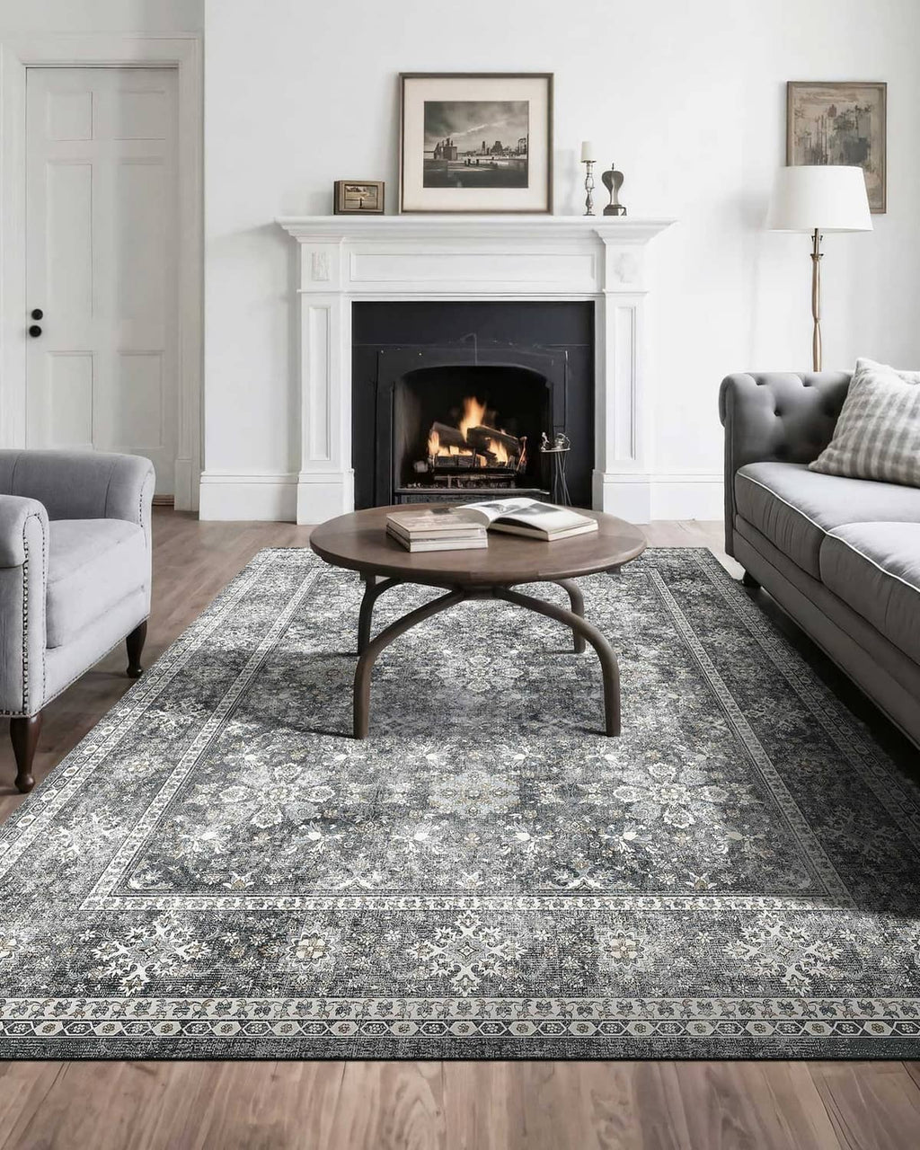 Gray vintage area rug with distressed floral medallion pattern and ornate border