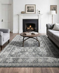 Gray vintage area rug with distressed floral medallion pattern and ornate border