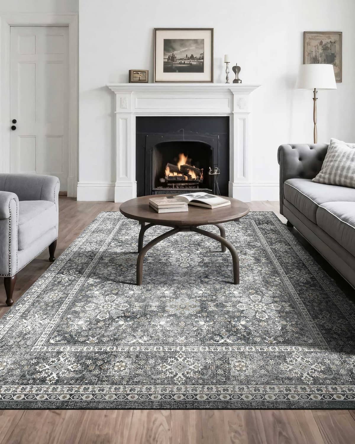 Gray vintage area rug with distressed floral medallion pattern and ornate border