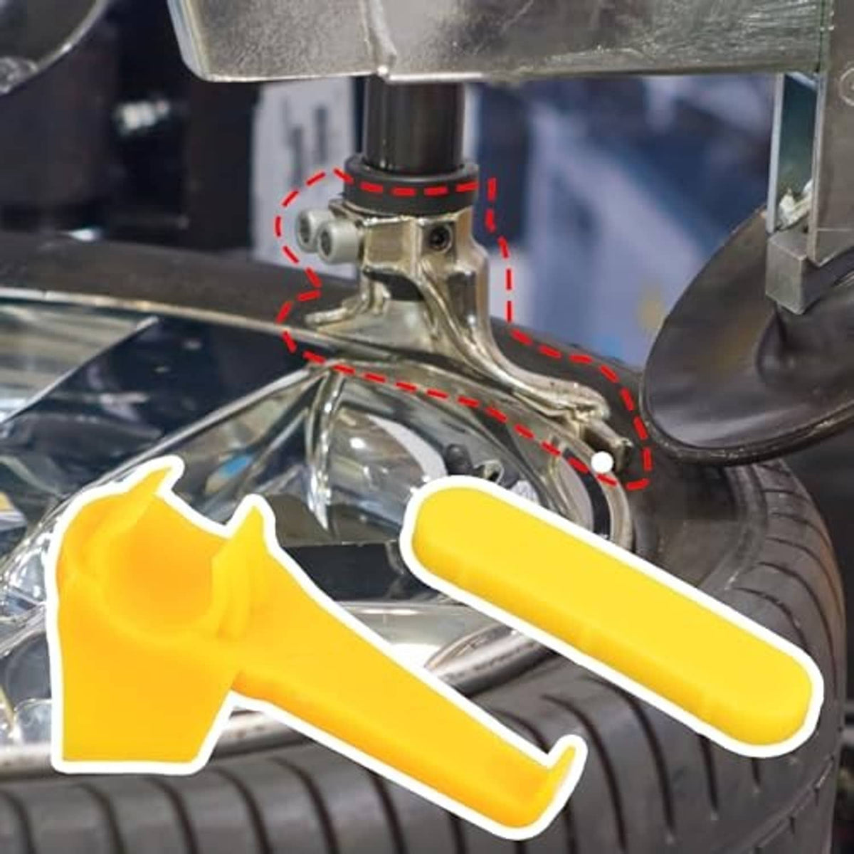Yellow duck-head inserts installed on a tire changer tool near the wheel rim