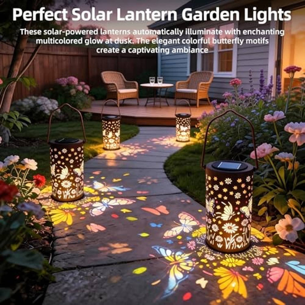 Set of glowing solar lanterns with butterfly patterns on outdoor walkway