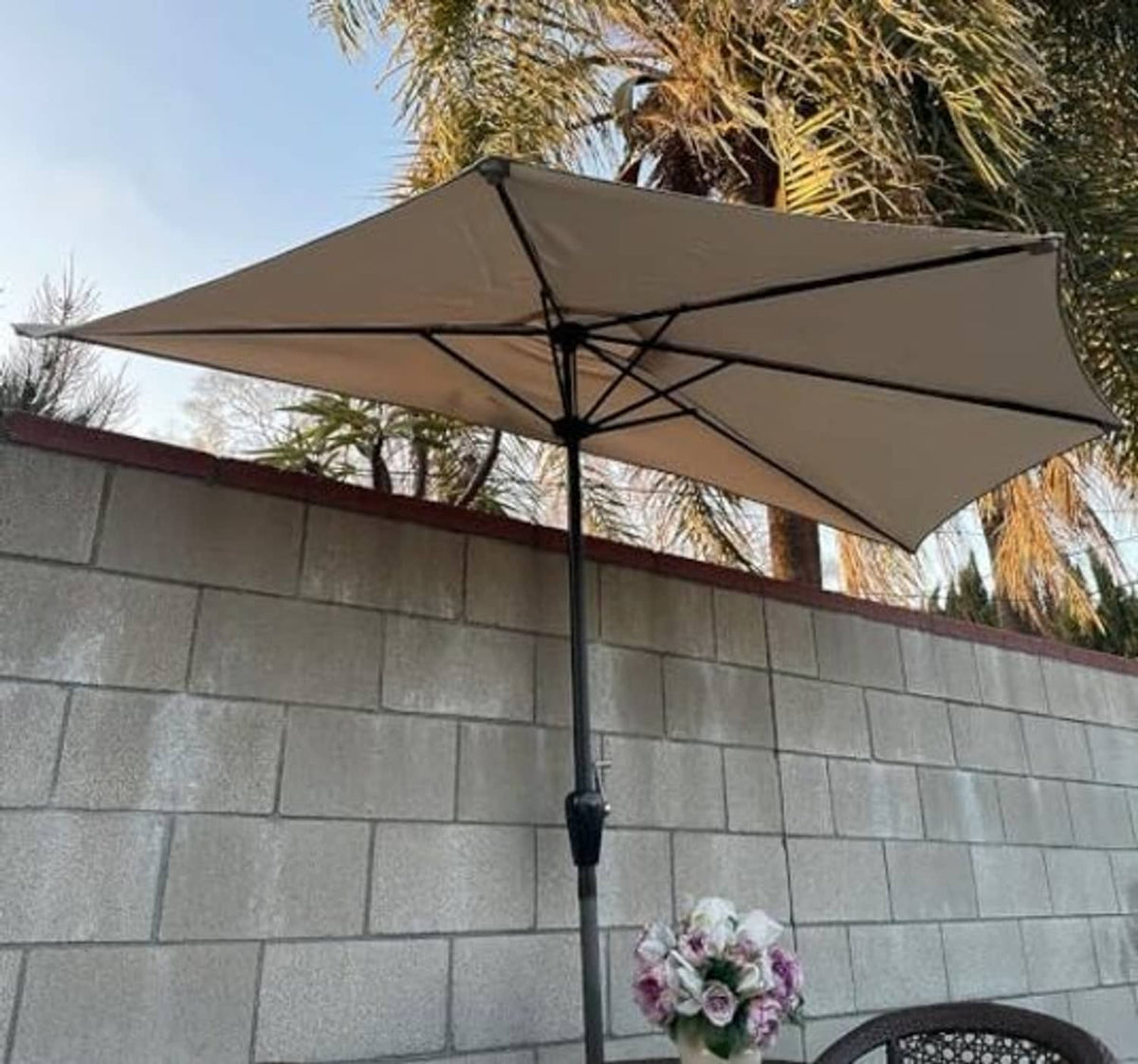Taupe umbrella canopy with black rib frame and central pole