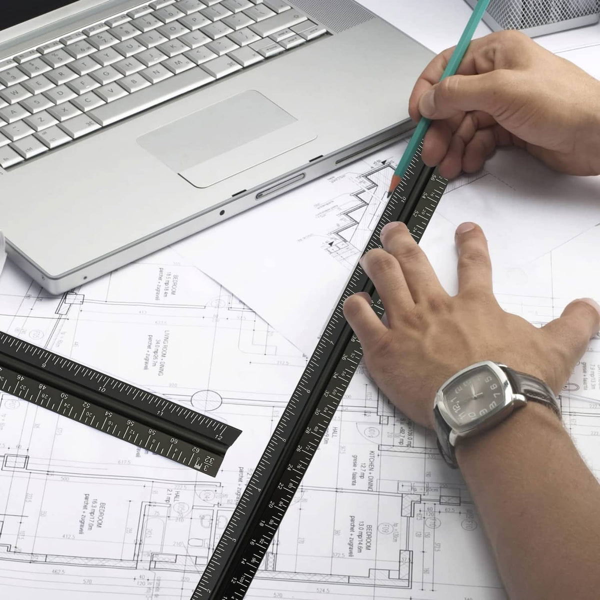 Architectural scale ruler used on blueprint drawings with hands guiding the measurements