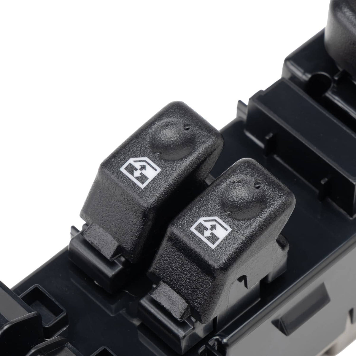 Close-up of two window control rocker switches with white icons on black plastic
