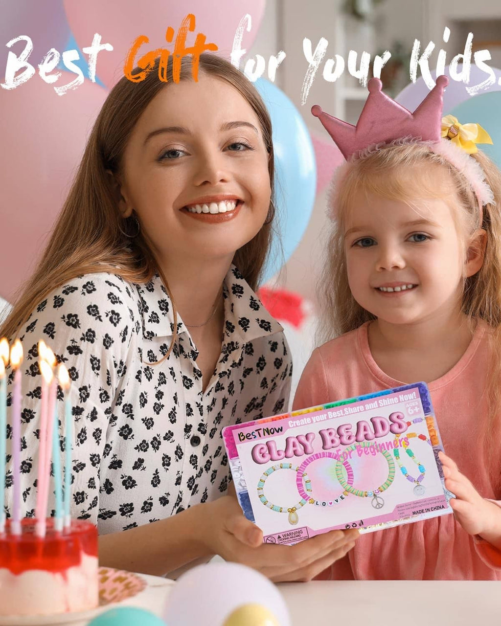 Child holding a clay beads bracelet kit card while a parent smiles beside her