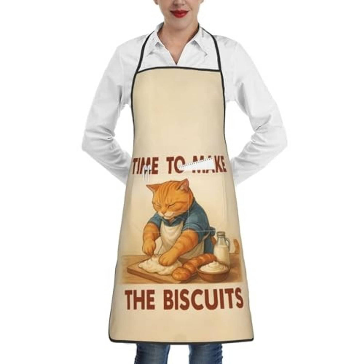 Beige chef bib apron worn over white shirt; cat baking graphic centered