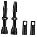 Black tubeless valve stems with rubber base and hex nut, plus two protective caps