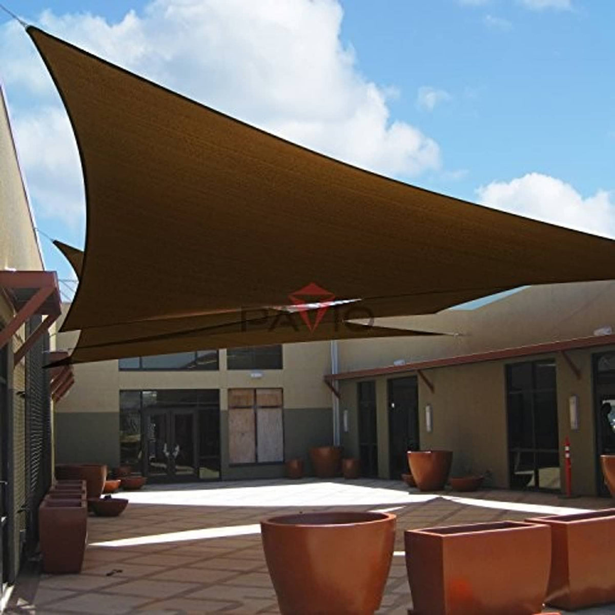 Large dark brown triangular sun shade sail canopy stretched overhead with grommets