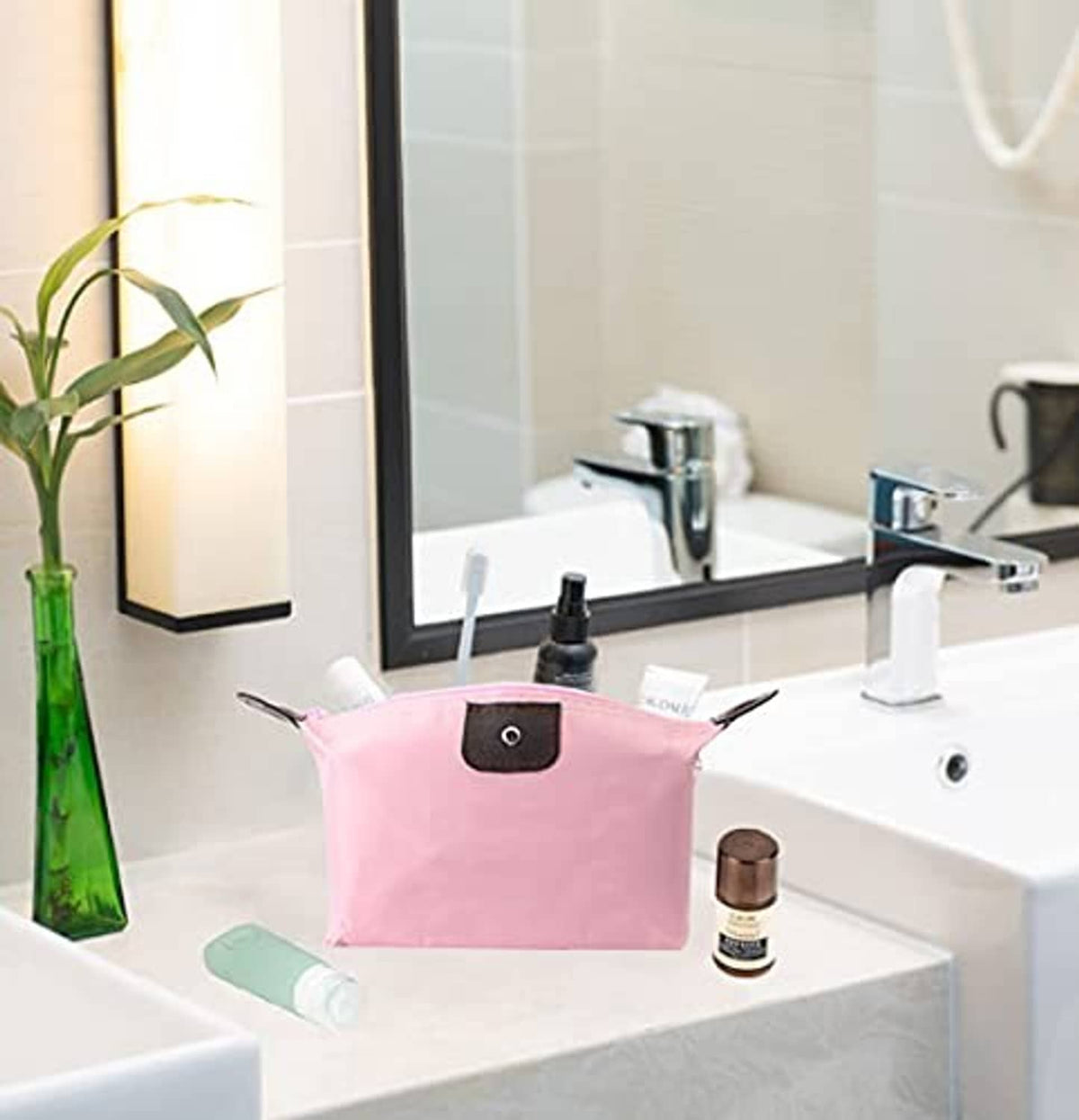 Pink waterproof makeup zip pouch with dark front patch and handle loop