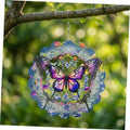 Colorful metal butterfly wind spinner with circular layered cutouts, hanging from a chain.