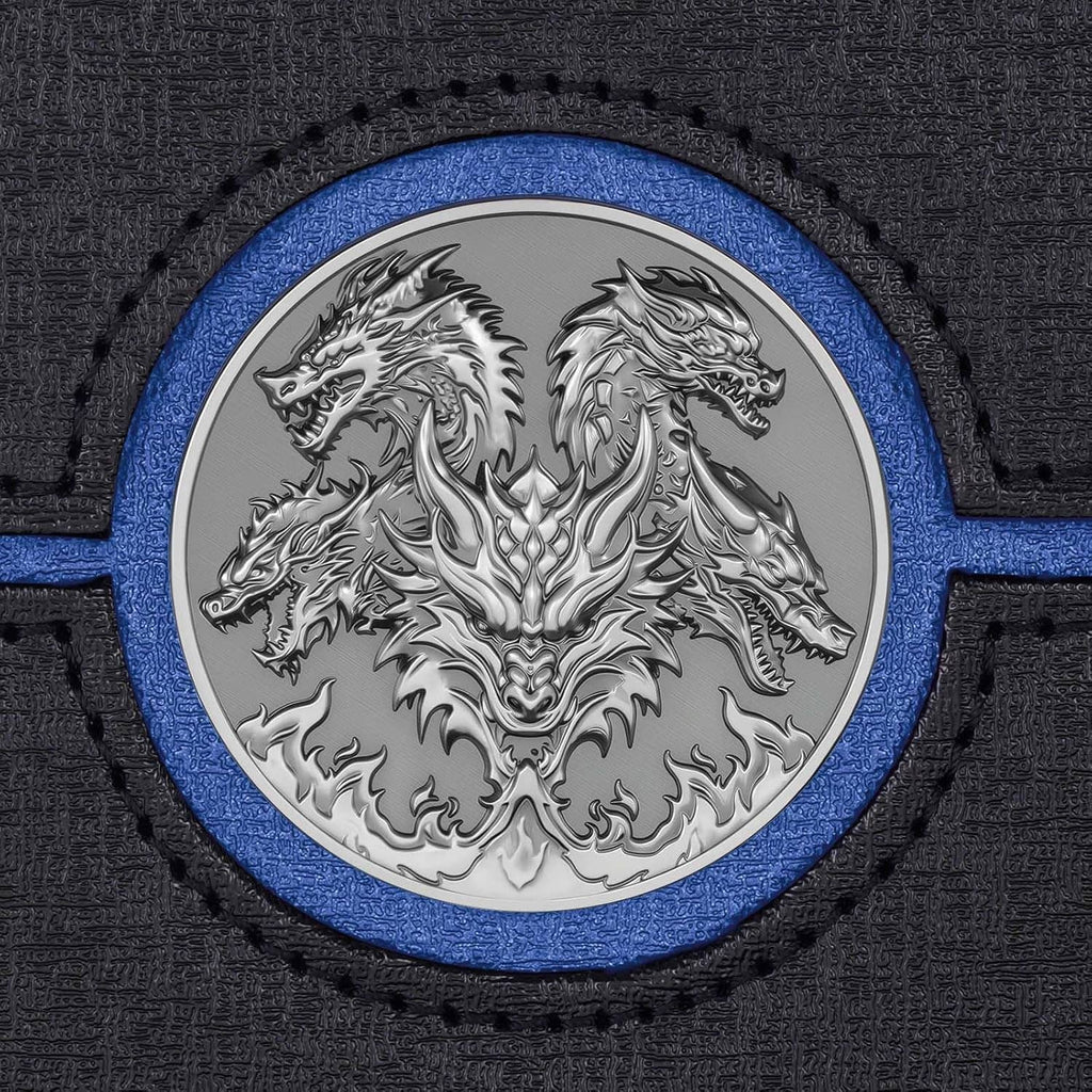 Close-up of metal dragon emblem on black and blue card deck box