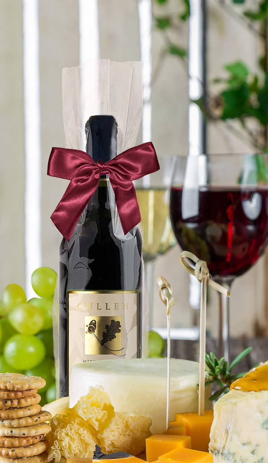 Clear cellophane bottle bag with burgundy ribbon bow, wine bottle gift display